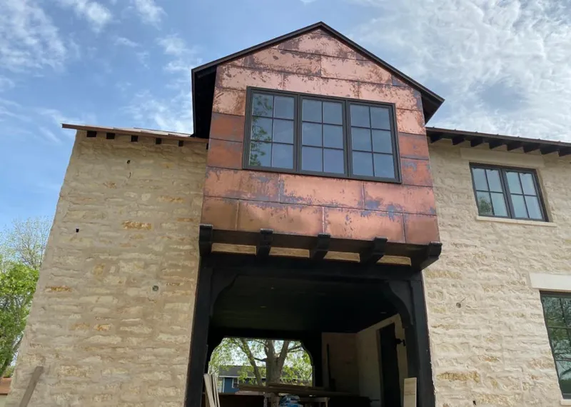 Copper metal panel facade on a stone building for Metal Roof Coating in Woodbury